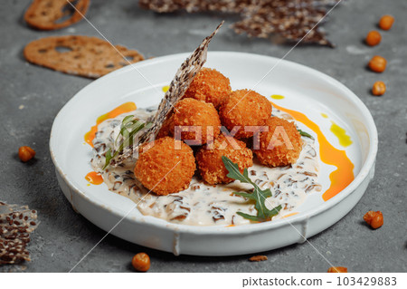 Potato croquettes - mashed potatoes balls breaded and deep fried, served with different sauce. Potato croquettes - mashed potatoes balls breaded and deep fried, served with different sauce. 103429883