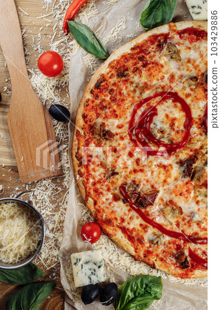 Pizza with chicken cheese and pepperoni, a piece of which is cut and laid out like a pakman, is on a wooden board and a brown background. Cheese spreads flowing streaks Pizza with chicken cheese and pepperoni, a piece of which is cut and laid out like a pakman, is on a wooden board and a brown background. Cheese spreads flowing streaks 103429886