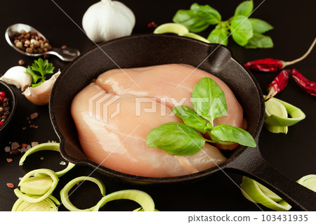 Top view.Chicken breast Fillets.Close up.Raw chicken meat.Raw fresh chicken fillet with fresh herbs on a black background.Food for retail.Ogranic food,healthy eating.Food concept. 103431935