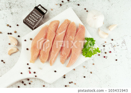 Raw fresh chicken fillet,gray background with fresh herbs.Food for retail.Procurement for designers.Ogranic food,healthy eating.Food concept.Top view.Chicken breast Fillets.Close up.Raw chicken meat. 103431943