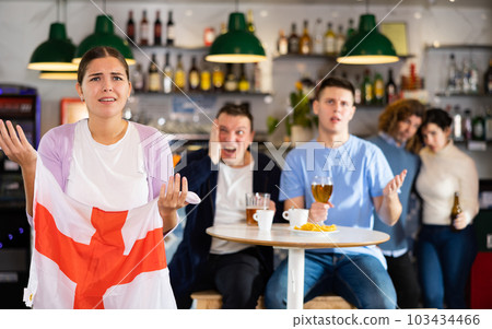 Group of fans of England team are upset by oss of their favorite team and express negative emotions in beer bar 103434466