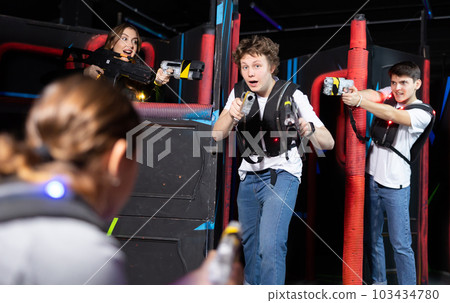 Three people playing lasertag in arena 103434780