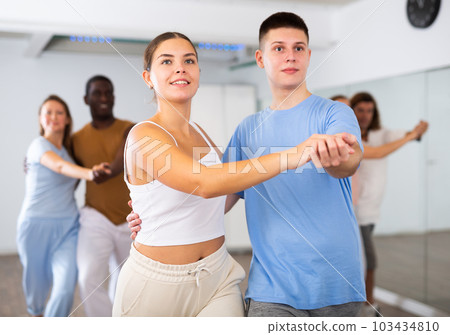 Young woman and teen boy dancing pair dance 103434810