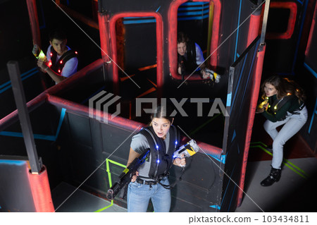 Team of young people play laser tag in labyrinth. View from above 103434811