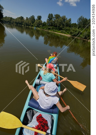 Canoeing on a river, girls in the boat Canoeing on a river, girls in the boat 103434986
