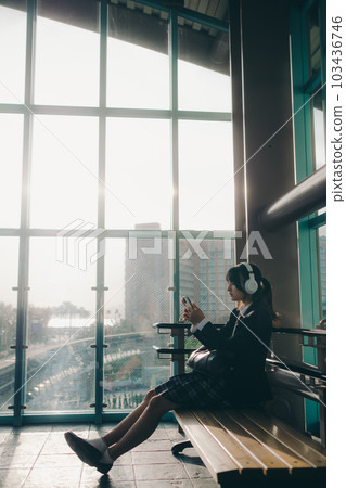 high school girl sitting on a bench 103436746