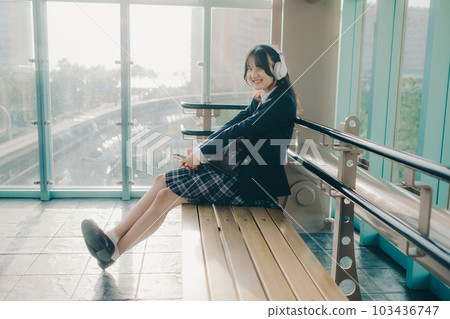 high school girl sitting on a bench 103436747