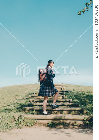 A high school girl standing in the sky 103436830