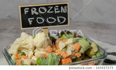 Frozen mixed vegetables for long-term storage with blackboard label and text FROZEN FOOD. Deep freezing of vegetables. defrosting Frozen food background 103437273