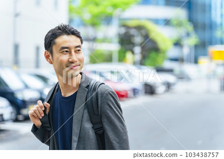 man standing in front of parking lot man standing in front of parking lot 103438757