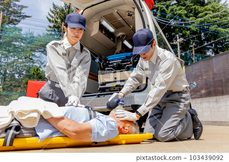 Paramedics using a resuscitator 103439092
