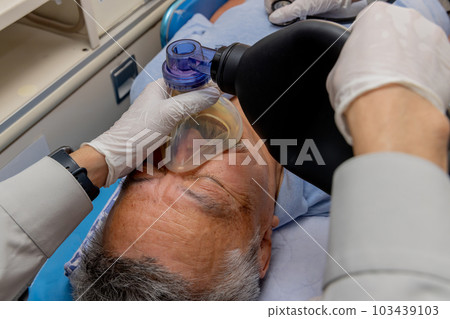 Paramedics using a resuscitator 103439103