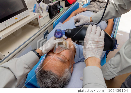 Paramedics using a resuscitator 103439104