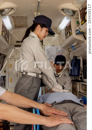Paramedics giving heart massage in an ambulance Paramedics giving heart massage in an ambulance 103439117