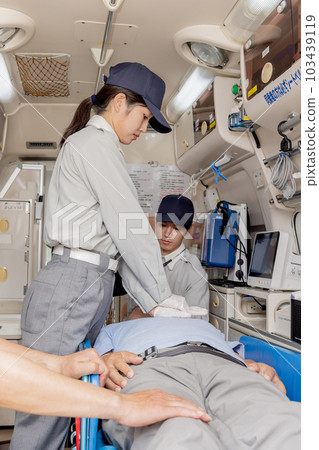 Paramedics giving heart massage in an ambulance Paramedics giving heart massage in an ambulance 103439119