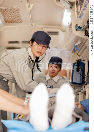An image of an ambulance worker using a stethoscope An image of an ambulance worker using a stethoscope 103439142