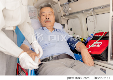 Patient wearing a pulse oximeter in an ambulance Patient wearing a pulse oximeter in an ambulance 103439445