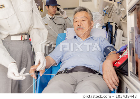Patient wearing a pulse oximeter in an ambulance 103439448