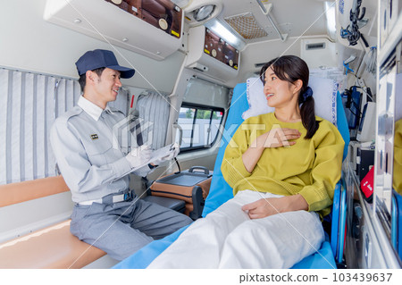 An ambulance worker asking a question to an unwell woman who called an ambulance An ambulance worker asking a question to an unwell woman who called an ambulance 103439637