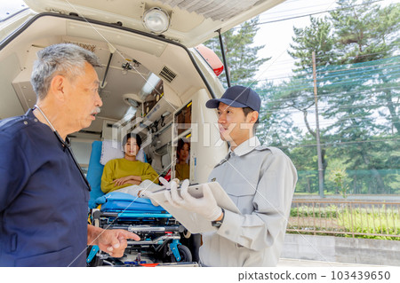Paramedics taking over with a doctor Paramedics taking over with a doctor 103439650