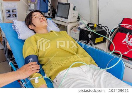 Young woman being transported by ambulance 103439651