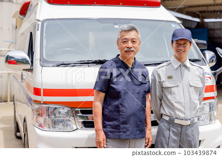Smiling paramedics and doctors in front of an ambulance 103439874
