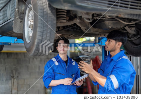 car mechanic car suspension detail of lifted automobile at repair service station 103439890