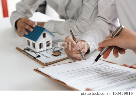 Happy couple signing a contract with real estate agent. renters tenants sign mortgage loan investment agreement or rental insurance contract meeting realtor lender landlord making real estate sale Happy couple signing a contract with real estate agent. renters tenants sign mortgage loan investment agreement or rental insurance contract meeting realtor lender landlord making real estate sale 103439919