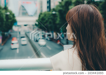 A Taiwanese woman standing on an overpass 103441093