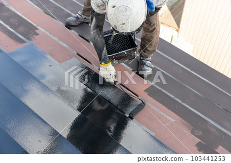 A craftsman painting roof tin A craftsman painting roof tin 103441253