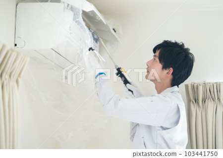 Male staff cleaning the air conditioner 103441750