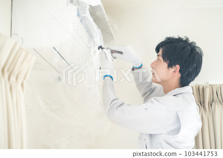 Male staff installing air conditioner 103441753