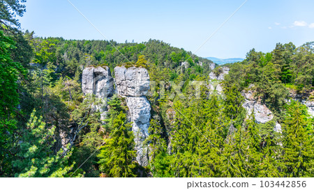 Panoramic view of a sandstone rock city in Bohemian Paradise, Czech: Cesky raj. Rock climbers on top of a rocky tower. Czech Republic Panoramic view of a sandstone rock city in Bohemian Paradise, Czech: Cesky raj. Rock climbers on top of a rocky tower. Czech Republic 103442856