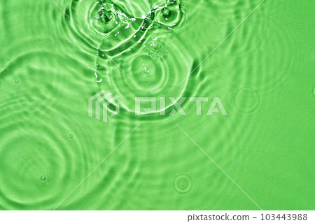 Light green water surface texture with splashes and bubbles. Abstract background for natural beauty products. Green water splashes wallpaper. 103443988