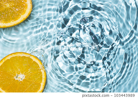 Creative summer background with orange fruit slices in swimming pool water. Summer wallpaper with copy space. Creative summer background with orange fruit slices in swimming pool water. Summer wallpaper with copy space. 103443989