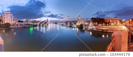 Sunset panorama over Seville, Guadalquivir river and golden tower Torre del Oro. Sunset panorama over Seville, Guadalquivir river and golden tower Torre del Oro. 103444179