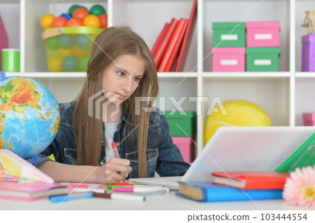 cute girl with laptop at home at desk cute girl with laptop at home at desk 103444554