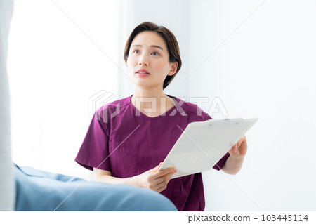 A woman in a wine red scrub A woman in a wine red scrub 103445114