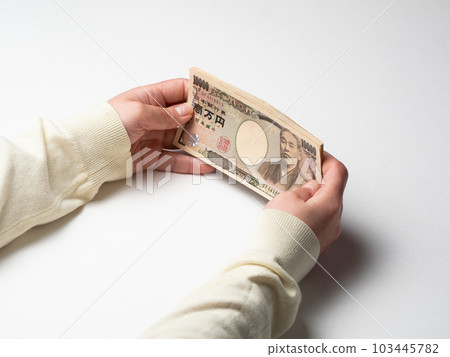 Woman's hand holding a lot of money Woman's hand holding a lot of money 103445782