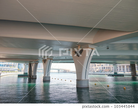 Empty street under a bridge in Dubai on a summer day Empty street under a bridge in Dubai on a summer day 103445844