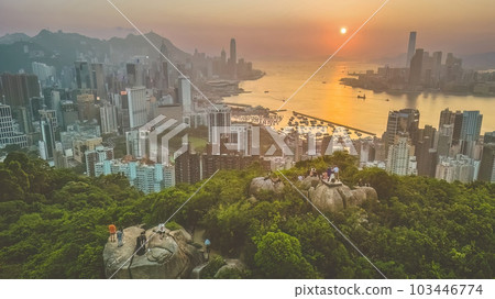 May 29 2023 Silhouette group of people who sits at a rock and takes photos May 29 2023 Silhouette group of people who sits at a rock and takes photos 103446774