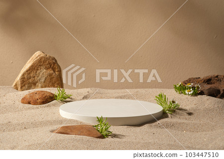 A white podium in round-shaped placed on the beach sand with some stones. Modern minimal showcase scene for cosmetic products promotion 103447510