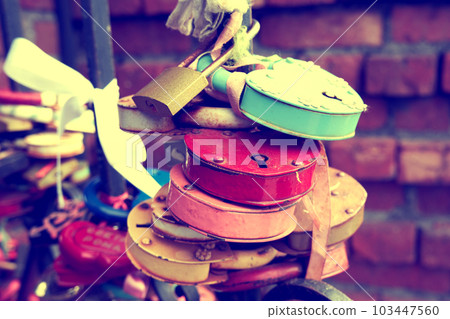 Lots of old love padlocks close up. Toned image 103447560