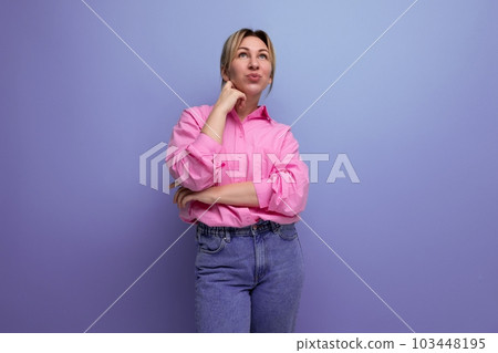 pretty young blond european woman model wearing pink shirt and jeans and feeling confident against pretty young blond european woman model wearing pink shirt and jeans and feeling confident against 103448195