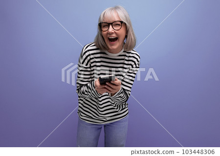middle aged business woman chatting on internet using smart phone on bright studio background middle aged business woman chatting on internet using smart phone on bright studio background 103448306