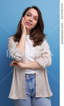 romantic charming brunette 30 year old female person dressed in a shirt and jeans on a studio romantic charming brunette 30 year old female person dressed in a shirt and jeans on a studio 103448334