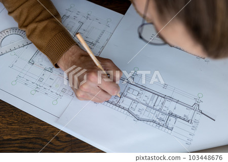 Unrecognizable architect designer sketching drawing design of house working on architectural project Unrecognizable architect designer sketching drawing design of house working on architectural project 103448676