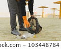 Garbage collection on the beach. Ecology concept. Copy space. Close-up view.  103448784