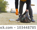 Garbage collection on the beach. Ecology concept. Copy space. Close-up view.  103448785