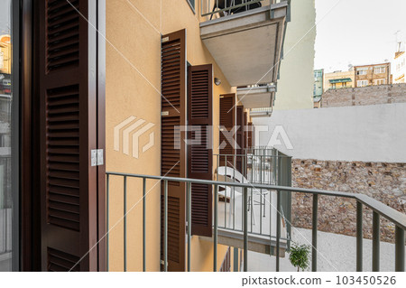 Access to an open loggia balcony in an apartment building with tables and chairs for a fresh air without leaving the house. The concept of comfortable modern housing Access to an open loggia balcony in an apartment building with tables and chairs for a fresh air without leaving the house. The concept of comfortable modern housing 103450526